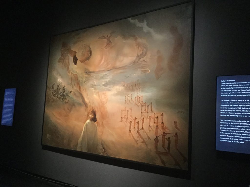 Salvador Dali's "Galacidalacidesoxiribunucleicacid (Homage to Crick and Watson)" painting. The link directly below this image and its caption goes to the Dali Museum's page on the painting, and gives a detailed description of the painting and its history.