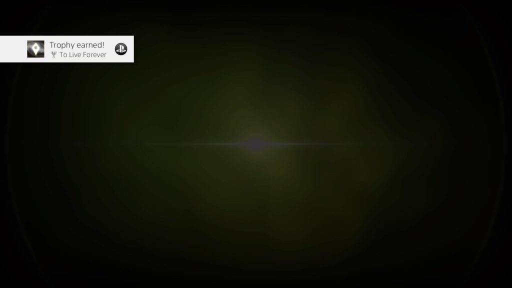 Screenshot of someone getting the "To Live Forever" Trophy in the video game No Man's Sky. A faint, greyish-green sunburst in the center of a black screen, with the "Trophy earned!" Playstation Network icon at top left.